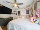 A bright bedroom showcases a comfortable bed, wall-mounted TV, and a sleek, dark dresser at 1102 Solana Cir, Davenport, FL 33897