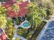 Overhead view of a clubhouse area featuring a hot tub, patio, and landscaped grounds at 1102 Solana Cir, Davenport, FL 33897