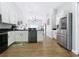 Bright kitchen boasts white cabinets, stainless steel appliances, sleek countertops, and seamlessly connects to living spaces at 1102 Solana Cir, Davenport, FL 33897