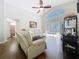 The open living area features a ceiling fan, a comfortable white sofa, and seamless transition to the screened-in pool at 1102 Solana Cir, Davenport, FL 33897