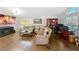 Spacious living room with wood floors, leather sofas, fireplace, and large windows for natural light at 1102 Solana Cir, Davenport, FL 33897