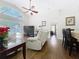 Relaxing living room with ceiling fan, large windows overlooking the screened-in pool, and inviting furniture at 1102 Solana Cir, Davenport, FL 33897