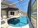 Inviting in-ground pool surrounded by a screened enclosure, a patio with seating, and lush greenery at 1102 Solana Cir, Davenport, FL 33897