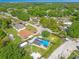 Beautiful aerial view of home with pool, fenced yard, and mature trees in a suburban setting at 1204 Pleasant Pl, Lakeland, FL 33801