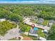 A high aerial view highlights the property in a lush, green neighborhood with mature trees at 1204 Pleasant Pl, Lakeland, FL 33801