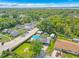 An aerial view of a lovely property with a pool and solar panels on the roof at 1204 Pleasant Pl, Lakeland, FL 33801