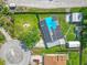 Aerial view of a property with a solar panel roof, large yard, fountain and detached garages at 1204 Pleasant Pl, Lakeland, FL 33801