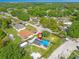Beautiful aerial view of home with pool, fenced yard, and mature trees in a suburban setting at 1204 Pleasant Pl, Lakeland, FL 33801