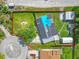 Aerial view of a property with a solar panel roof, large yard, fountain and detached garages at 1204 Pleasant Pl, Lakeland, FL 33801