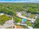 A high aerial view highlights the property in a lush, green neighborhood with mature trees at 1204 Pleasant Pl, Lakeland, FL 33801