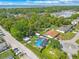 An aerial view showcases this home with its pool and solar panels at 1204 Pleasant Pl, Lakeland, FL 33801