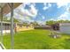 Expansive backyard with lush lawn, storage sheds, and a chicken coop, perfect for outdoor activities at 1204 Pleasant Pl, Lakeland, FL 33801