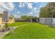 Spacious backyard features a large green lawn, storage sheds, and secure chicken coop at 1204 Pleasant Pl, Lakeland, FL 33801