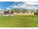 Expansive backyard with lush green grass and a screened-in patio for relaxing outdoors at 1204 Pleasant Pl, Lakeland, FL 33801