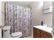 Bathroom featuring a toilet, and shower with patterned curtain at 1204 Pleasant Pl, Lakeland, FL 33801