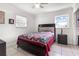Well-lit bedroom with tile floors, a colorful quilt, and a window at 1204 Pleasant Pl, Lakeland, FL 33801
