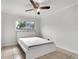 Well-lit bedroom with tile floors, a ceiling fan, and a window at 1204 Pleasant Pl, Lakeland, FL 33801