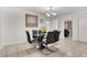 Modern dining room featuring a glass table and views of the laundry room at 1204 Pleasant Pl, Lakeland, FL 33801