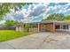 Charming single-story brick home featuring a covered front porch and spacious driveway at 1204 Pleasant Pl, Lakeland, FL 33801