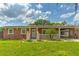 Charming single-story brick home with a covered front porch and well-maintained lawn at 1204 Pleasant Pl, Lakeland, FL 33801