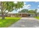 Charming single-story brick home featuring a covered front porch and spacious driveway at 1204 Pleasant Pl, Lakeland, FL 33801