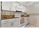 Efficient kitchen with white cabinets, granite countertops, and modern appliances at 1204 Pleasant Pl, Lakeland, FL 33801