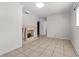 Bright living room with a decorative fireplace, neutral tile flooring, and fresh white paint at 1204 Pleasant Pl, Lakeland, FL 33801
