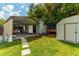 The backyard features a workshop with a chicken coop and an additional storage shed at 1204 Pleasant Pl, Lakeland, FL 33801