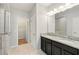 Bathroom featuring double vanity with granite countertop, tile floors, and glass-enclosed shower at 1370 Kiawah St, Celebration, FL 34747