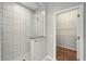 Bathroom showcasing a glass-enclosed shower with white tile and a doorway to a walk-in closet at 1370 Kiawah St, Celebration, FL 34747