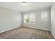 Bedroom featuring neutral walls, plush carpet, crown molding, and two windows with blinds at 1370 Kiawah St, Celebration, FL 34747