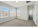 Bedroom with neutral walls, plush carpet, two windows, and access to a closet and bathroom at 1370 Kiawah St, Celebration, FL 34747