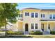 Charming two-story townhouse featuring a well-maintained front yard and inviting facade at 1370 Kiawah St, Celebration, FL 34747