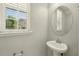 Cozy half bath features a modern pedestal sink at 1370 Kiawah St, Celebration, FL 34747