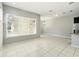 Open living area featuring large windows, and tile flooring, next to kitchen at 1370 Kiawah St, Celebration, FL 34747