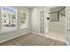 Bright office featuring two windows with blinds, gray walls, and a door leading to the tiled staircase at 1370 Kiawah St, Celebration, FL 34747