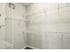 Walk-in closet with white wire shelving and neutral-colored walls and carpet at 1370 Kiawah St, Celebration, FL 34747