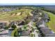An aerial view of a home in a golf community with manicured lawns and mature trees at 1821 N Hampton Dr, Davenport, FL 33897