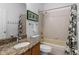 Well-lit bathroom featuring a granite-top vanity and a shower-over-tub combination at 1821 N Hampton Dr, Davenport, FL 33897