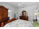 Bedroom features a ceiling fan, wood furniture, and a glimpse into a walk-in closet at 1821 N Hampton Dr, Davenport, FL 33897