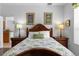 Comfortable bedroom features a wooden headboard, two side tables, and decoratively framed pictures at 1821 N Hampton Dr, Davenport, FL 33897