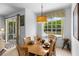 Dining area with hardwood floors, a wooden table set for six, and views of the screened patio at 1821 N Hampton Dr, Davenport, FL 33897