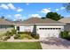 Charming single Gathering home featuring a well maintained lawn and a two car garage at 1821 N Hampton Dr, Davenport, FL 33897