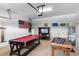 Spacious garage set up as a recreation room with a pool table, foosball table and laundry area at 1821 N Hampton Dr, Davenport, FL 33897