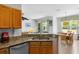 Kitchen with granite countertops, stainless steel appliances, and an open view to the dining room at 1821 N Hampton Dr, Davenport, FL 33897