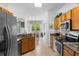 Well-lit kitchen boasts granite countertops and stainless steel appliances, adjacent to a cozy dining area at 1821 N Hampton Dr, Davenport, FL 33897