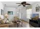Bright living room with hardwood floors, comfortable seating, a ceiling fan, and entryway views at 1821 N Hampton Dr, Davenport, FL 33897