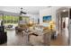 Open-concept living room features hardwood floors, comfortable seating, and natural light from large windows at 1821 N Hampton Dr, Davenport, FL 33897