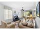 Bright living room features hardwood floors, comfortable seating, a ceiling fan, and sliding doors to screened patio at 1821 N Hampton Dr, Davenport, FL 33897