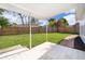 Spacious backyard featuring a covered patio, a well-maintained lawn, and a wood fence at 201 La Paz Dr, Kissimmee, FL 34743
